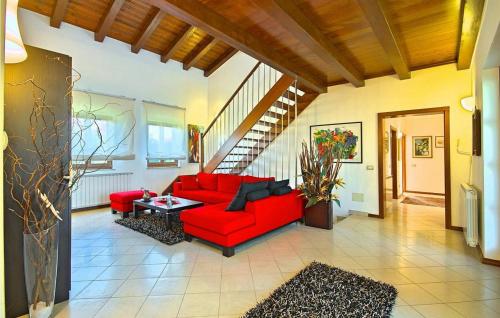 a living room with a red couch and a table at Villa Ciano in Višnjan
