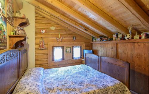 a bedroom with a bed in a wooden cabin at Amazing Apartment In Borno With Kitchen in Borno