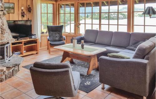 a living room with a couch and a table at Hytte Nr 4-156 in Frafjord