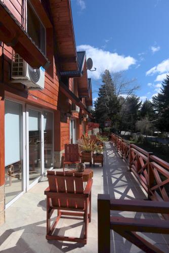 a row of benches sitting outside of a building at Amutuy Bariloche in San Carlos de Bariloche