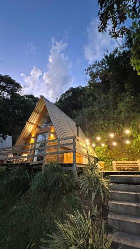 a large wooden house with a gambrel roof at Cabanas Bela Vista in Rolante
