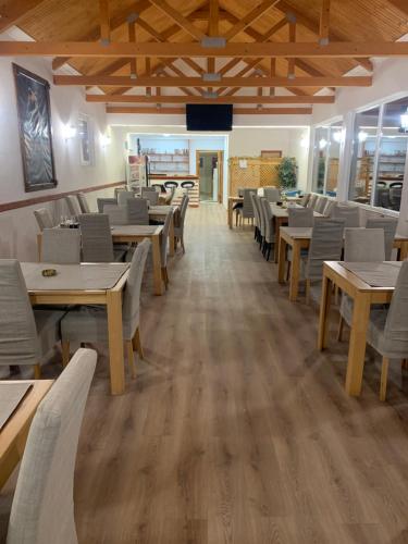 a dining room with wooden tables and chairs at Papa Bear Bjelasnica in Trnovo