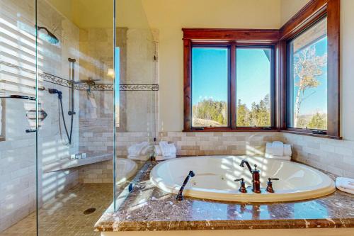 a large bathroom with a tub and a shower at Mountain Breeze Retreat in Edwards