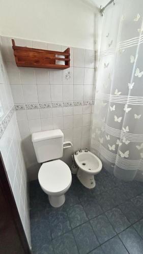 a small bathroom with a toilet and a bidet at 760 C Apartamentos in Alta Gracia