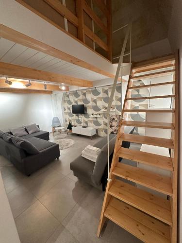 a living room with a staircase and a couch at La casetta di Sofia in Altamura