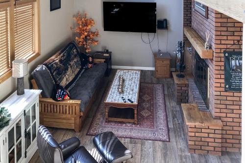 a living room with a couch and a tv at Sunsets in Thermopolis in Thermopolis