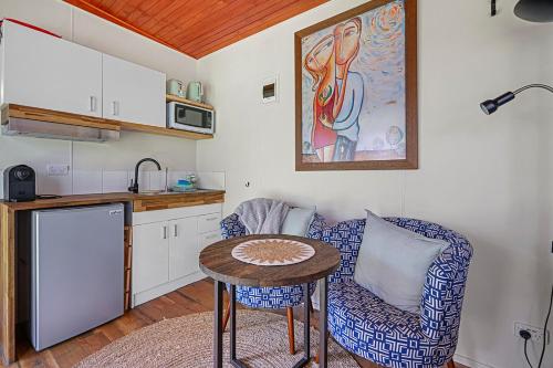 a living room with a table and a kitchen at Meadowbrook Tiny House - Stay among the best wineries in Orange in Orange