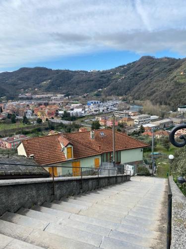 a view of a city with houses and mountains at IL SOLE DI AURORA in Carasco