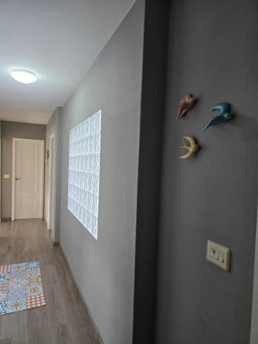 a hallway with a wall with two animal heads on it at Spacious apartment with sea view in O Grove, 110 m² in O Grove