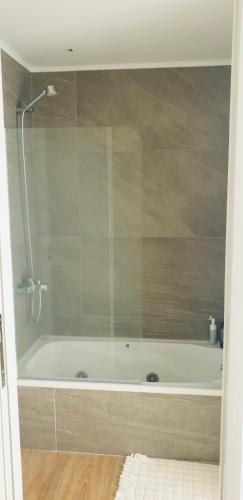a bathroom with a bath tub with a shower at EG12 Playa Grande in Mar del Plata
