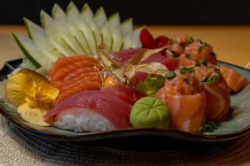 a plate full of sushi on a table at Complexo Eco Cataratas Resort by SJ in Foz do Iguaçu