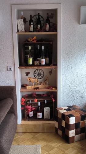 a shelf with bottles of wine in a room at Haus Helga in Albersweiler