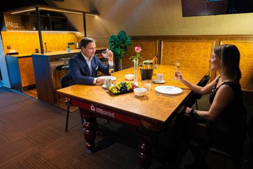 a man and two women sitting around a table at SPA Hotell Peetrimõisa Villa in Viljandi