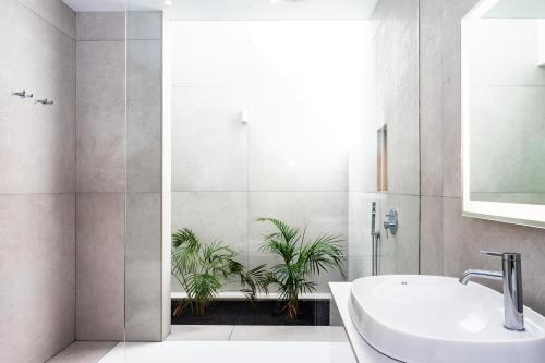a bathroom with a sink and two potted plants at Villa Tenik in Teguise