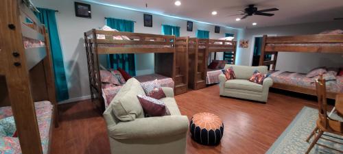a room with two bunk beds and two chairs at Trinity Lodge in Ferguson