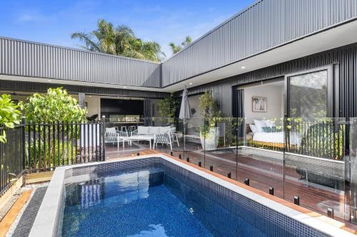 a swimming pool in front of a house at Stylish Home near Noosa & Peregian, walk to Beach in Marcus Beach