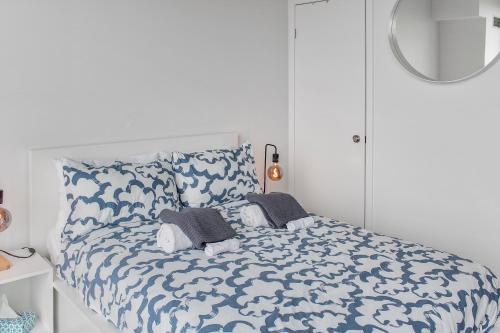 a bedroom with a blue and white bed with pillows at City View Towers - Steps to CN Tower - Pool & Hot tub - Free Parking in Toronto