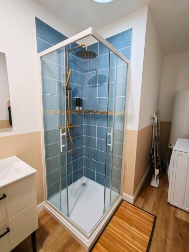 a shower with a glass door in a bathroom at Bohème en Garonne in Tonneins
