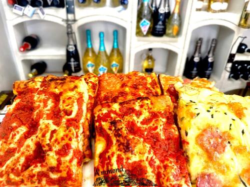 three slices of pizza sitting on top of a table at All'Arco Casa Vacanza in Acerenza