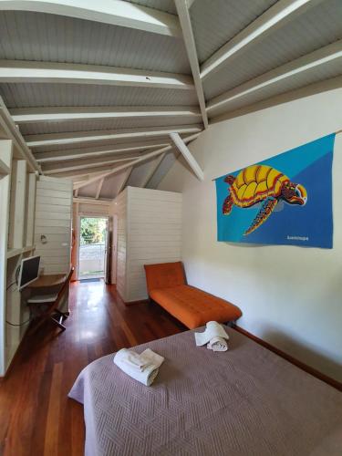 a bedroom with a bed and a couch in a room at Le repère des Pirates in Les Abymes