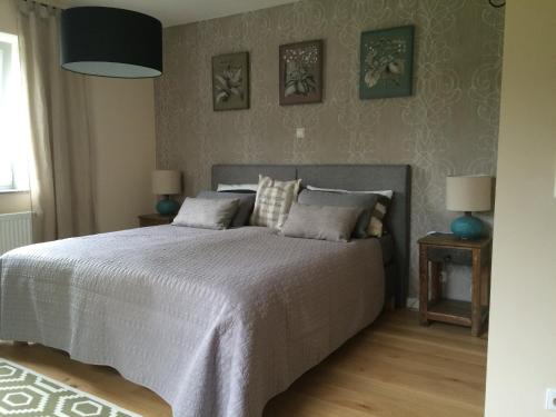 a bedroom with a large bed and two lamps at Im Feldle in Kirchheim am Ries