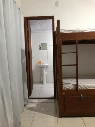 a bathroom with a bunk bed and a sink at Casa Vibra Luz Guest House Familiar in Florianópolis