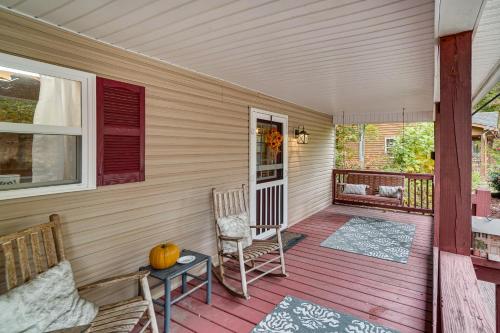 a porch with two chairs and a table at Spacious Home in Helen with Porch and Balcony! in Helen