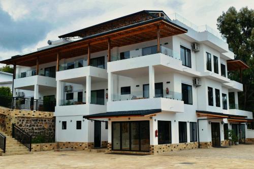 a large white building with a roof at Moshono Hillside in Arusha