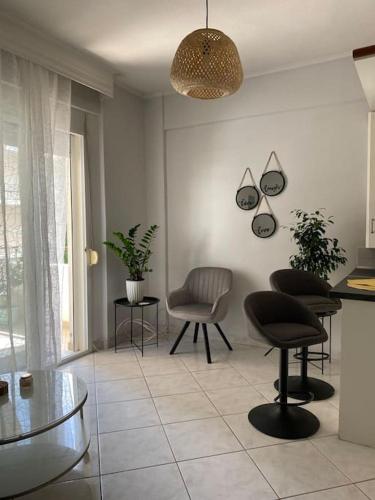 a living room with two chairs and a table at Sweet Suite in Serres