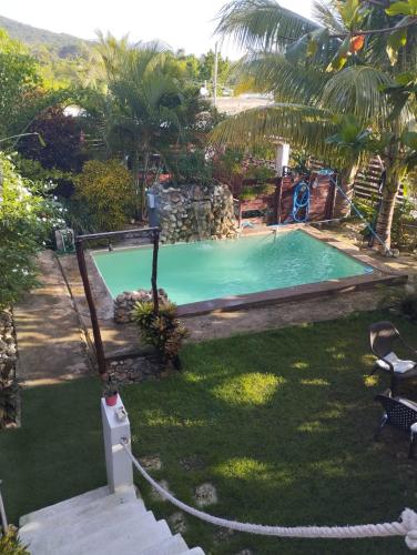 an image of a swimming pool in a yard at ECOVILLA CORAL GARDEN in Baoruco
