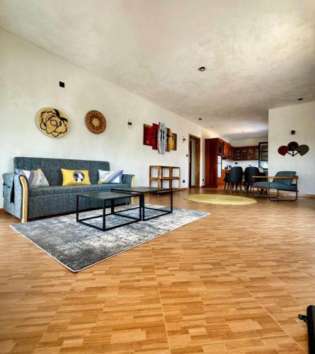 a living room with a couch and a table at Moshono Hillside in Arusha