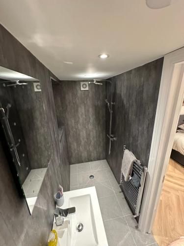 a bathroom with a sink and a shower at 6 bedroom house in Orpington in Farnborough