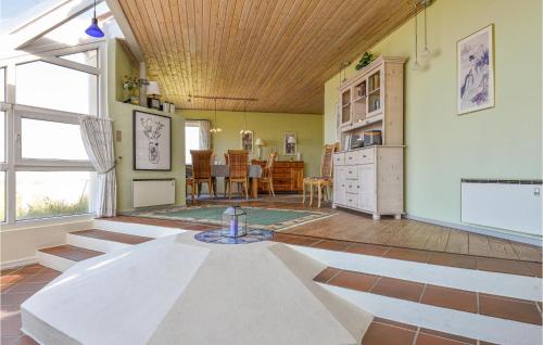 a living room with a table in the middle of it at Holiday Home Nørre Nebel 56 in Nymindegab