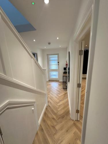a hallway with a staircase in a house at 6 bedroom house in Orpington in Farnborough