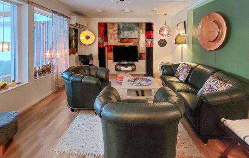 a living room with leather chairs and a table at Beautiful Home In Höganäs With Wifi in Höganäs
