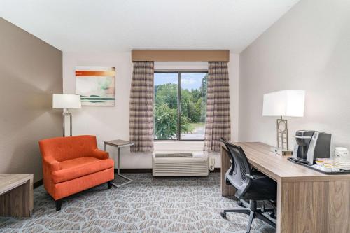 a hotel room with a desk and a chair and a window at Best Western Kernersville in Kernersville