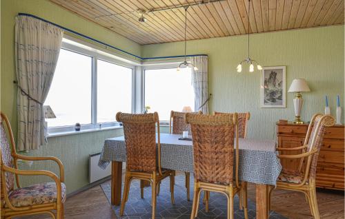 a dining room with a table and chairs at Holiday Home Nørre Nebel 56 in Nymindegab