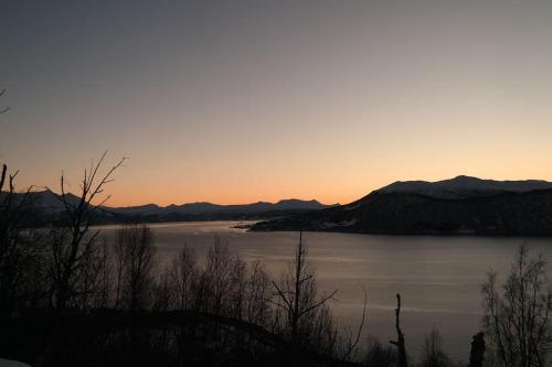 a view of a body of water at sunset at Arctic Aurora View in Ytre Tomasjord