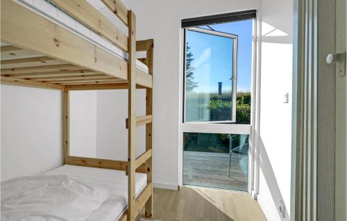 a small bedroom with a bunk bed and a window at Amazing Home In Bogø By With Wifi in Bogø By