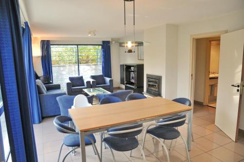 a dining room and living room with a table and chairs at Résidence Durbuy in Durbuy