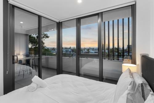 a bedroom with a bed and a balcony with a view at The Haven - Brand New Riverview 2BR with Parking Pool GYM at Surfers Paradise in Gold Coast