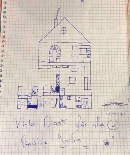 a drawing of a house on a sheet of paper at Chalet Julia mit Sauna in Eisten