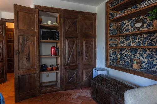 a living room with wooden doors and a couch at Giant Smart Room, Hot tub, PS5, in Historical Sintra Center inside 17th century Palace - Sintra WOW in Sintra
