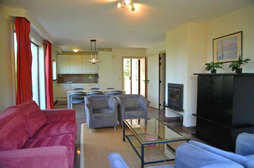 a living room with a couch and chairs and a table at Résidence Durbuy in Durbuy