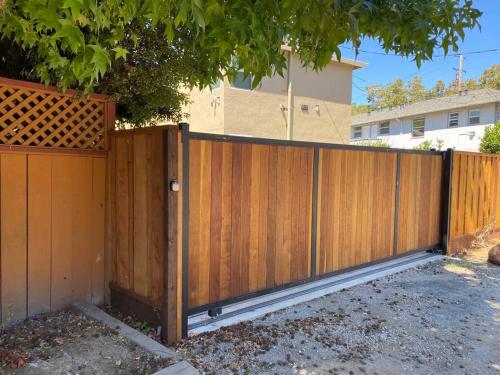 a wooden fence in front of a house at 4 Stanford! Furnished Apartment, Gated Parking, Laundry in East Palo Alto