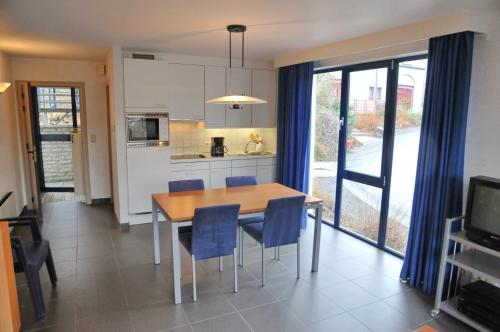 a kitchen and dining room with a table and chairs at Résidence Durbuy in Durbuy
