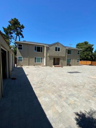 a large house with a large driveway in front of it at 4 Stanford! Furnished Apartment, Gated Parking, Laundry in East Palo Alto
