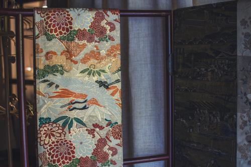 a curtain with a floral pattern on a window at 佐渡古民家一棟貸切 Active Art Hotel 日本庭園 佐渡アート in Sado