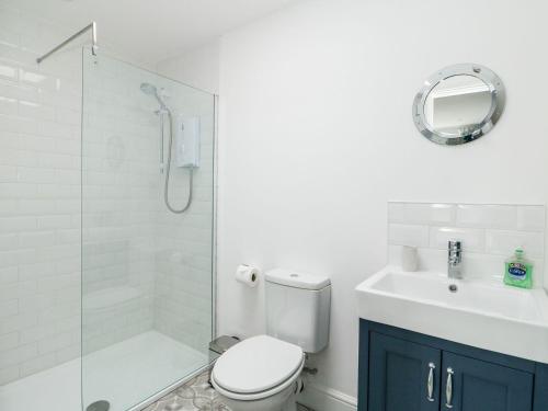 a bathroom with a shower and a toilet and a sink at The Seaside Retreat in Mablethorpe