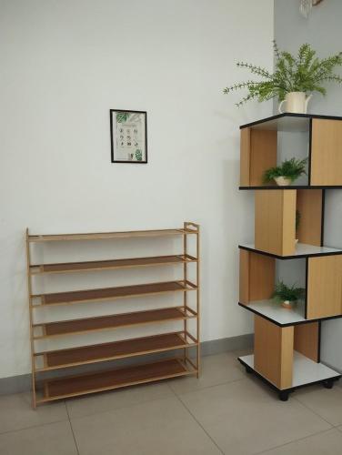 a room with shelves and plants on a wall at Dedaun Homestay Batu Pahat in Batu Pahat